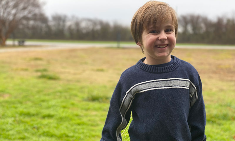 Harrison smiling in a field