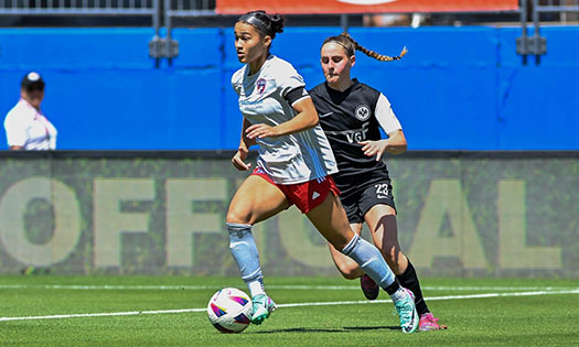 Young girl playing soccer.