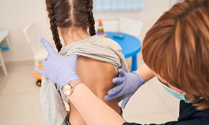 Doctor examining patients back