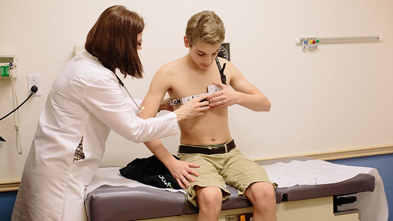 young boy wearing a dynamic compression brace