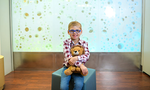 Young boy holding a teddy bear.